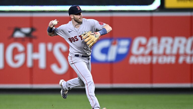 Trevor Story of the Boston Red Sox throws the ball to first base against the Baltimore Orioles at Oriole Park.