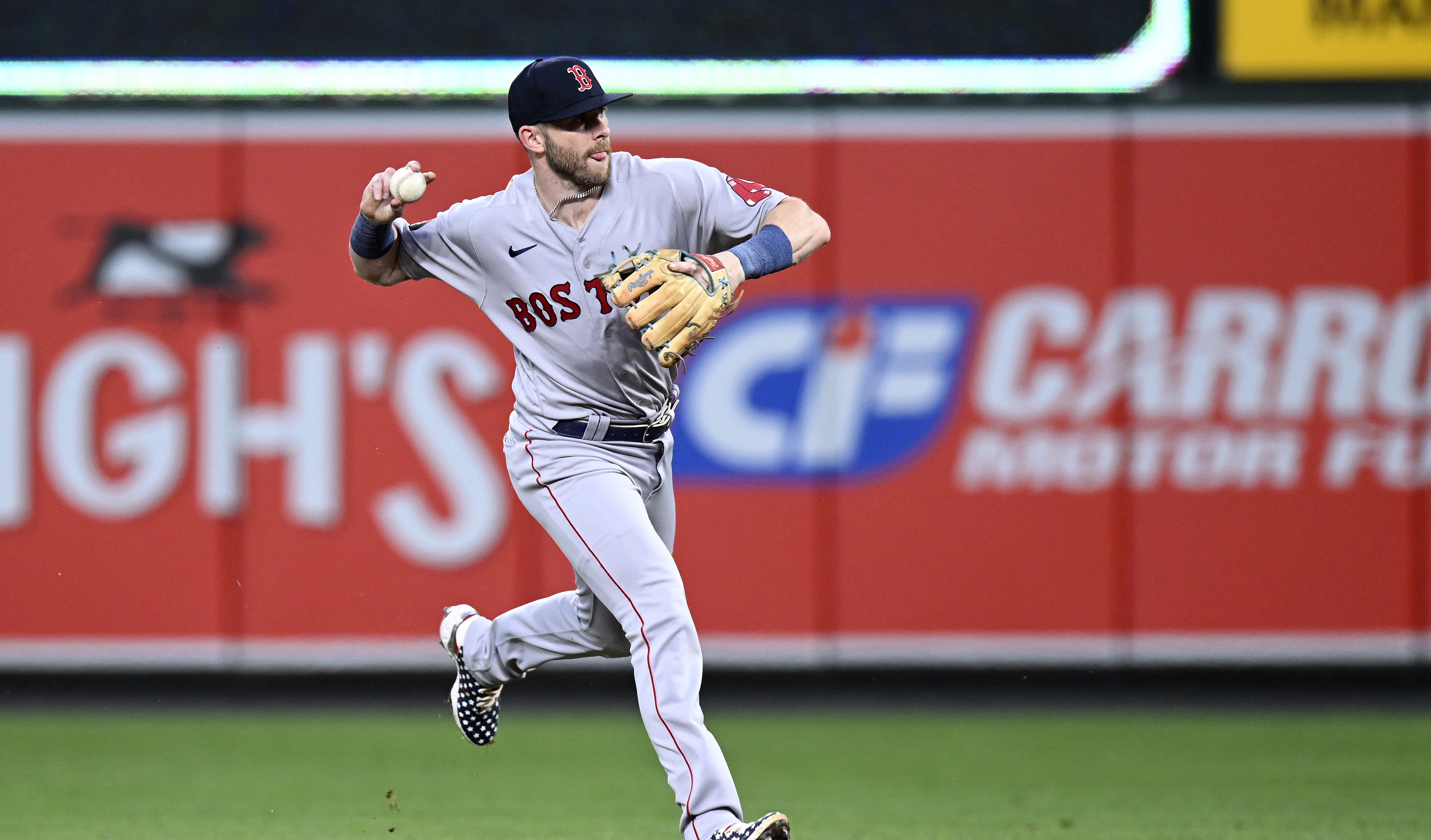 Trevor Story of the Boston Red Sox throws the ball to first base against the Baltimore Orioles at Oriole Park.