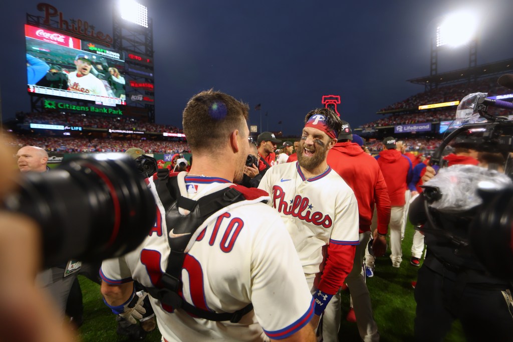 Bryce Harper celebrates with J.T. Realmuto after defeating the San Diego Padres in the NLCS
