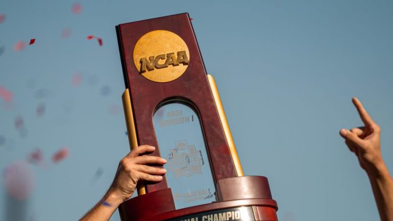 OMAHA, NE - June 26: The National Championship trophy is lifted by the Ole Miss Rebels after winning the Men's College World Series game at Charles Schwab Field on June 26, 2022 in Omaha, Nebraska. Ole Miss defeated Oklahoma in the second game of the championship series to win the National Championship. (Photo by Eric Francis/Getty Images)