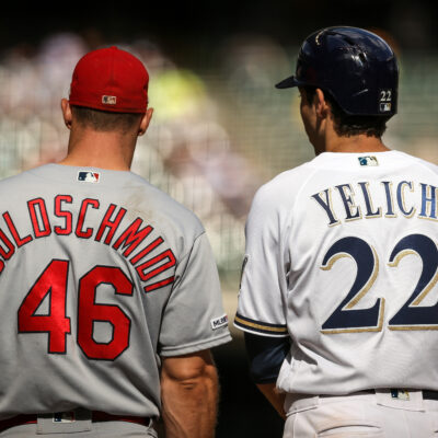 Paul Goldschmidt #46 of the St. Louis Cardinals and Christian Yelich #22 of the Milwaukee Brewers meet at first base in the eighth inning at Miller Park.