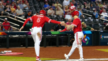 Freddie Freeman of Team Canada his greeted by teammate Tyler O'Neill after scoring a run in the first inning during Game 3 of Pool C between Team Great Britain and Team Canada at Chase Field.