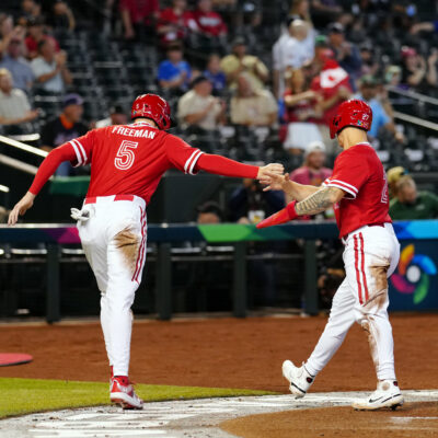 Freddie Freeman of Team Canada his greeted by teammate Tyler O'Neill after scoring a run in the first inning during Game 3 of Pool C between Team Great Britain and Team Canada at Chase Field.