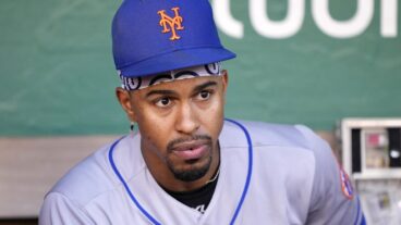 Francisco Lindor #12 of the New York Mets looks on from the dugout while preparing for his game against the Oakland Athletics at RingCentral Coliseum.