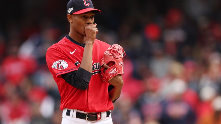 Triston McKenzie of the Cleveland Guardians reacts after issuing a walk in the second inning to Isaac Paredes #17 of the Tampa Bay Rays in game two of the Wild Card Series at Progressive Field.