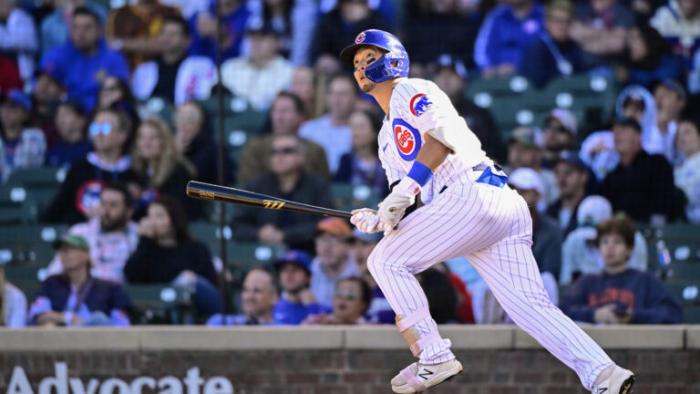 Seiya Suzuki of the Chicago Cubs hits a home run in the seventh inning against the Cincinnati Reds at Wrigley Field.