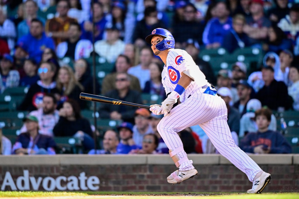 Seiya Suzuki of the Chicago Cubs hits a home run in the seventh inning against the Cincinnati Reds at Wrigley Field.