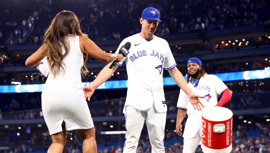 Chris Bassitt of the Toronto Blue Jays is doused with water by Vladimir Guerrero Jr. #27 after throwing a complete game against the Atlanta Braves at Rogers Centre.