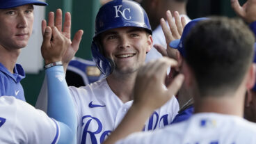 Michael Massey of the Kansas City Royals is congratulated by teammates after scoring on a Maikel Garcia single in the fourth inning against the Detroit Tigers at Kauffman Stadium.