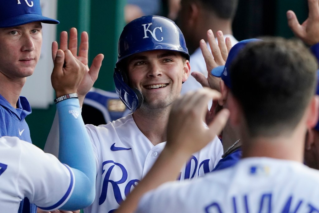 Michael Massey of the Kansas City Royals is congratulated by teammates after scoring on a Maikel Garcia single in the fourth inning against the Detroit Tigers at Kauffman Stadium.