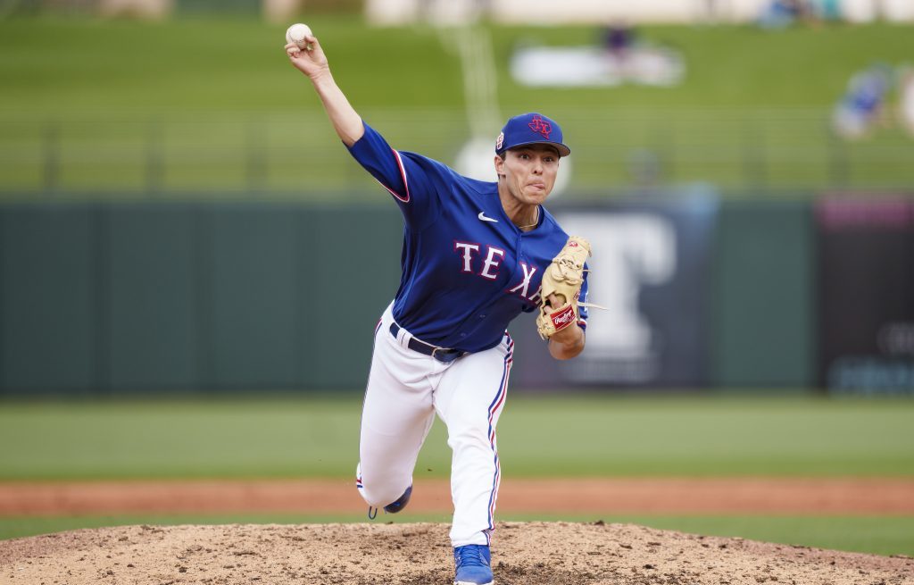 Jack Leiter of the Texas Rangers delivers a pitch during a spring training game against the Colorado Rockies at Surprise Stadium.