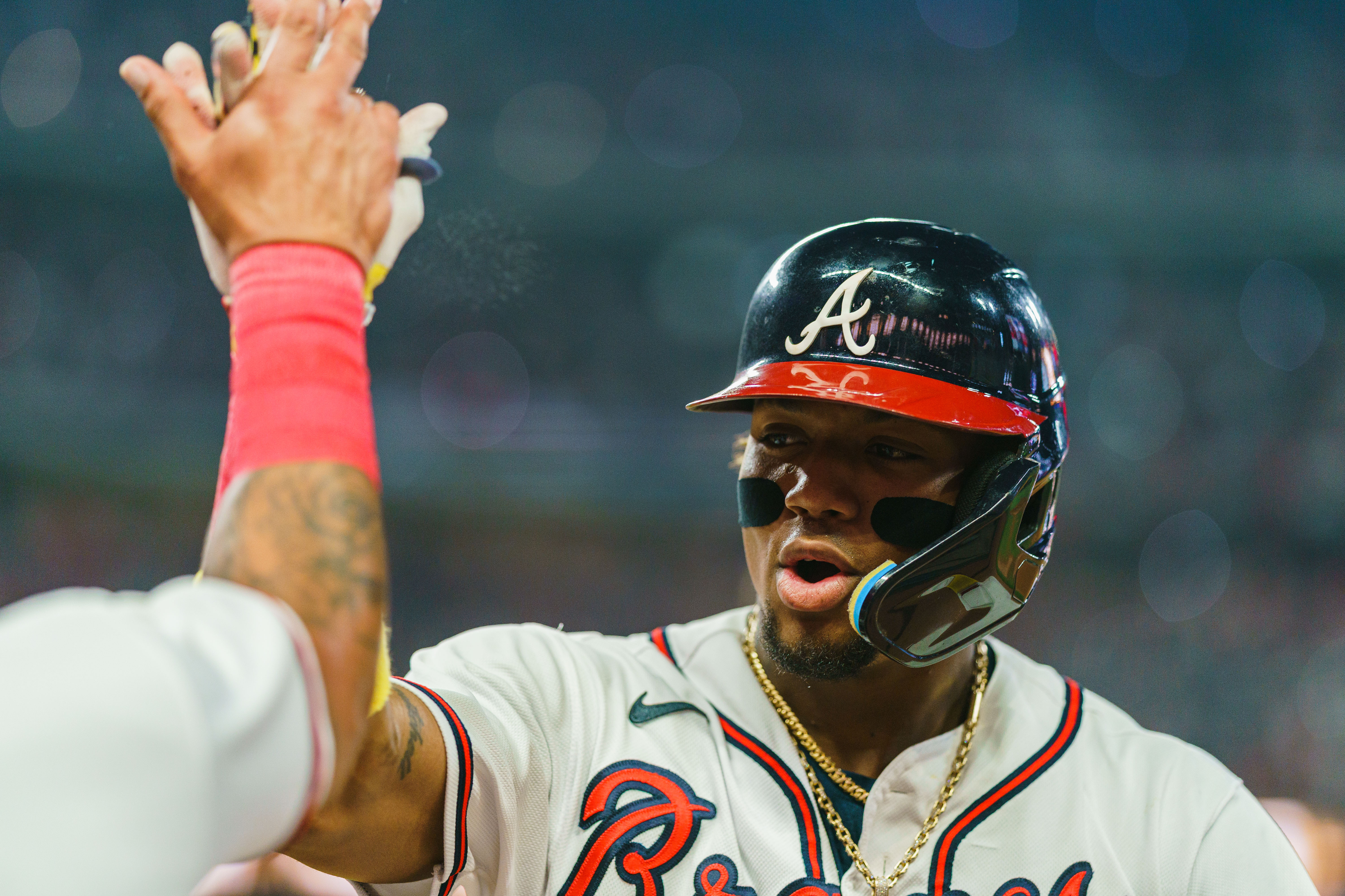 Ronald Acuña Jr. of the Atlanta Braves celebrates during the sixth inning against the New York Mets at Truist Park.