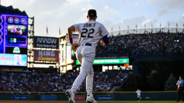 Nolan Jones of the Colorado Rockies runs onto the field to play defense in the fifth inning of a game against the Los Angeles Angels at Coors Field.