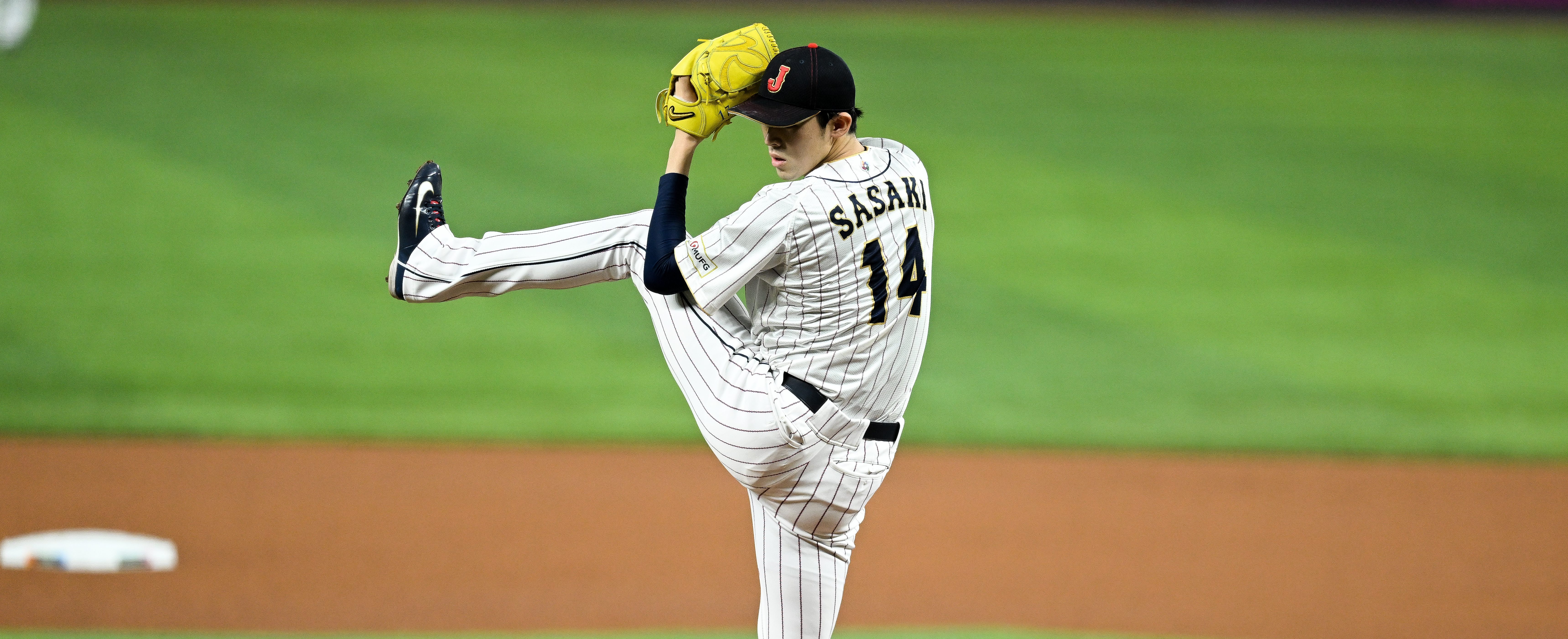 Roki Sasaki #14 of Team Japan pitches in the top of the first inning during the World Baseball Classic Semifinals between Mexico and Japan at loanDepot park.