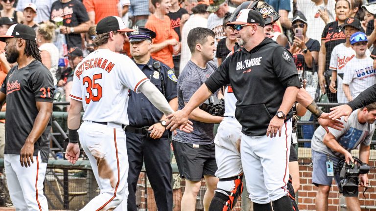 Baltimore Orioles manager Brandon Hyde (18) congratulates designated hitter Adley Rutschman (35) following the Houston Astros versus the Baltimore Orioles on August 10, 2023 at Oriole Park at Camden Yards.