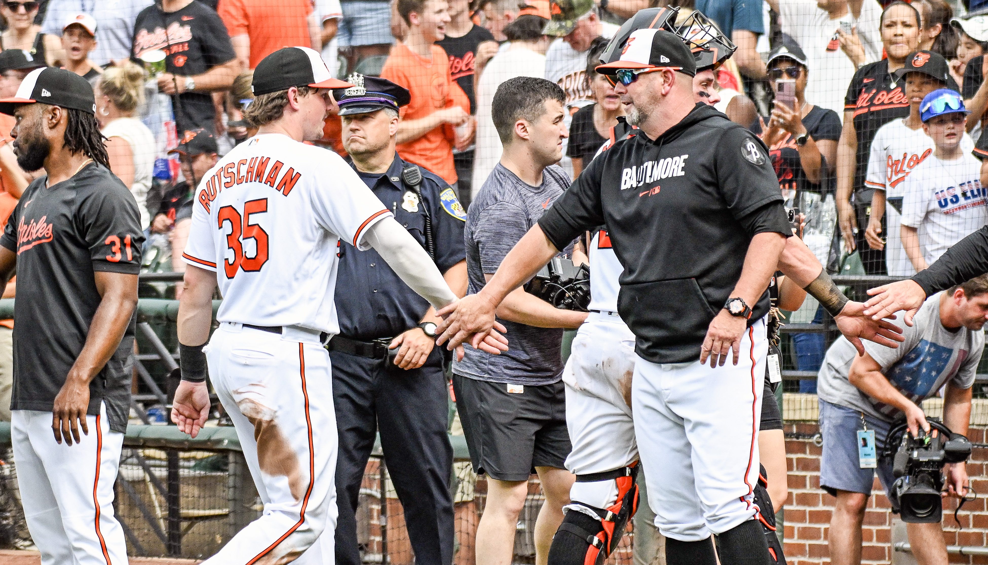 Baltimore Orioles manager Brandon Hyde (18) congratulates designated hitter Adley Rutschman (35) following the Houston Astros versus the Baltimore Orioles on August 10, 2023 at Oriole Park at Camden Yards.
