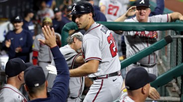 Matt Olson #28 of the Atlanta Braves reacts with teammates after hitting a solo home run during the fourth inning against the Philadelphia Phillies at Citizens Bank Park.