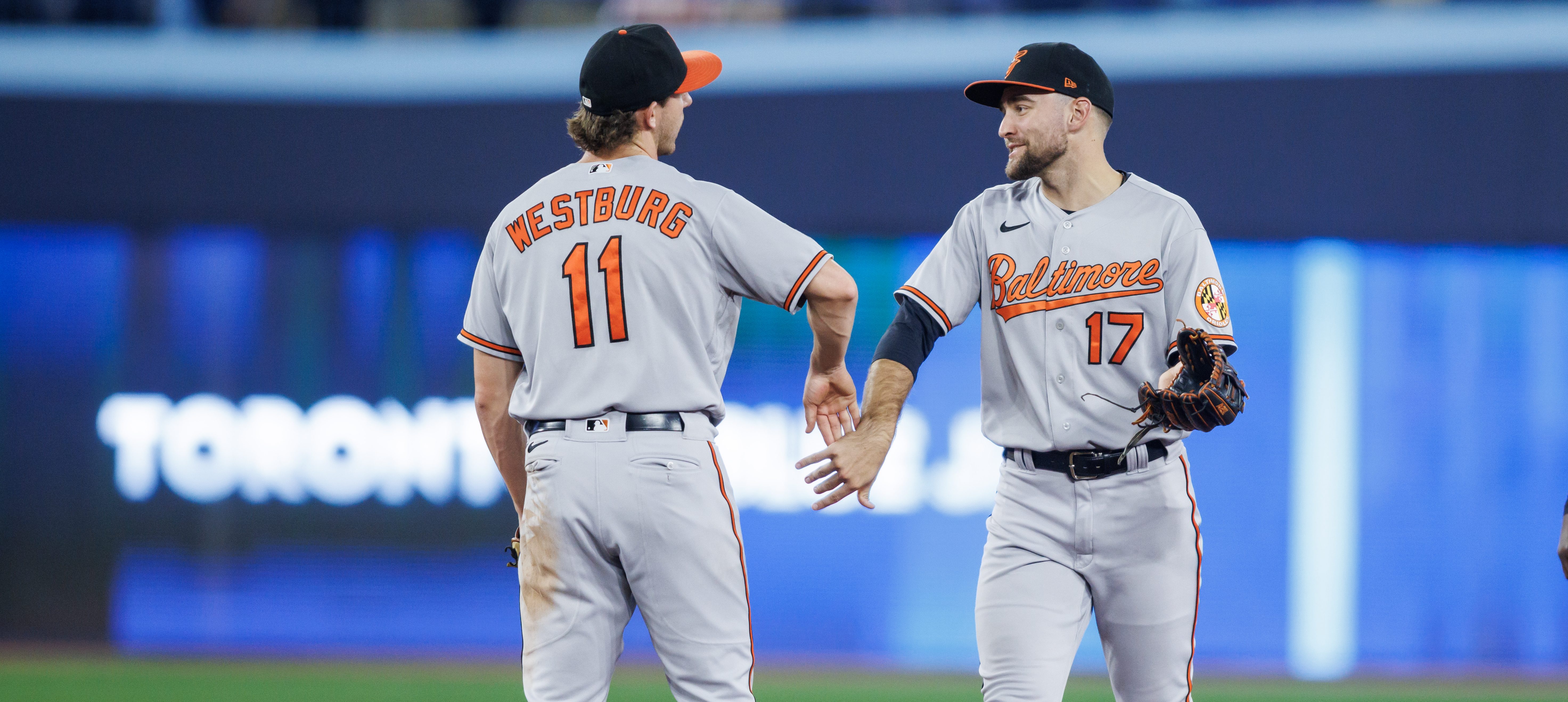 Young stars Jordan Westburg and Colton Cowser of the Baltimore Orioles celebrates their MLB game win over the Toronto Blue Jays at Rogers Centre.