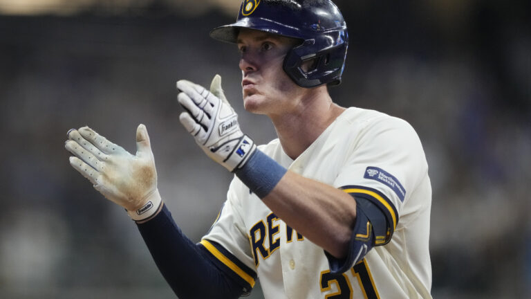 Mark Canha of the Milwaukee Brewers hits an RBI single during the eighth inning against the Arizona Diamondbacks in Game Two of the Wild Card Series at American Family Field.