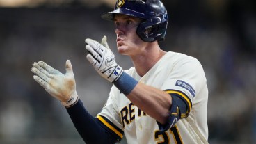 Mark Canha of the Milwaukee Brewers hits an RBI single during the eighth inning against the Arizona Diamondbacks in Game Two of the Wild Card Series at American Family Field.