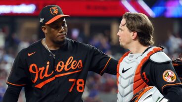 One of the Baltimore Orioles relievers, Yennier Cano, and catcher Adley Rutschman walk back to the dugout after the eighth inning against the Texas Rangers during a postseason game (Game Three of the Division Series) at Globe Life Field.