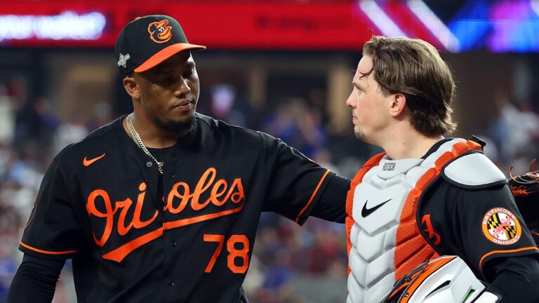 One of the Baltimore Orioles relievers, Yennier Cano, and catcher Adley Rutschman walk back to the dugout after the eighth inning against the Texas Rangers during a postseason game (Game Three of the Division Series) at Globe Life Field.