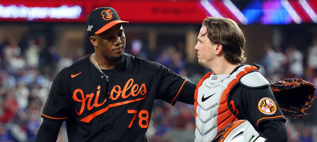 One of the Baltimore Orioles relievers, Yennier Cano, and catcher Adley Rutschman walk back to the dugout after the eighth inning against the Texas Rangers during a postseason game (Game Three of the Division Series) at Globe Life Field.