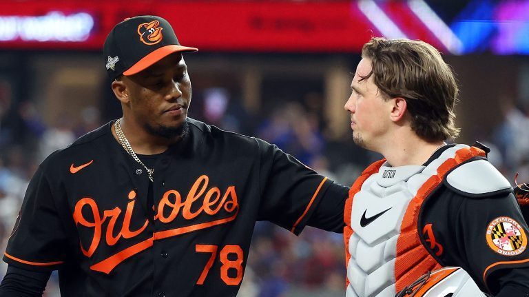 Yennier Cano #78 and Adley Rutschman #35 of the Baltimore Orioles walk back to the dugout after the eighth inning against the Texas Rangers during Game Three of the Division Series at Globe Life Field.