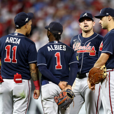 Orlando Arcia #11, Ozzie Albies #1, Austin Riley #27 and Matt Olson #28 of the Atlanta Braves talk against the Philadelphia Phillies during the eighth inning in Game Three of the Division Series at Citizens Bank Park.