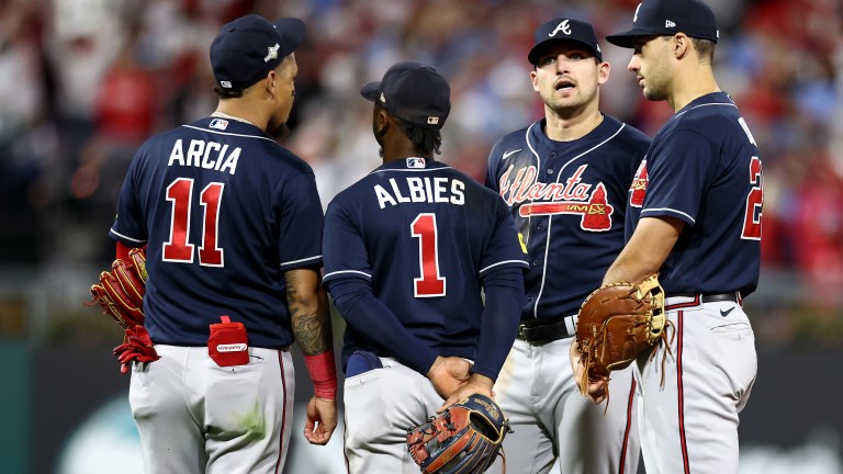 Orlando Arcia #11, Ozzie Albies #1, Austin Riley #27 and Matt Olson #28 of the Atlanta Braves talk against the Philadelphia Phillies during the eighth inning in Game Three of the Division Series at Citizens Bank Park.