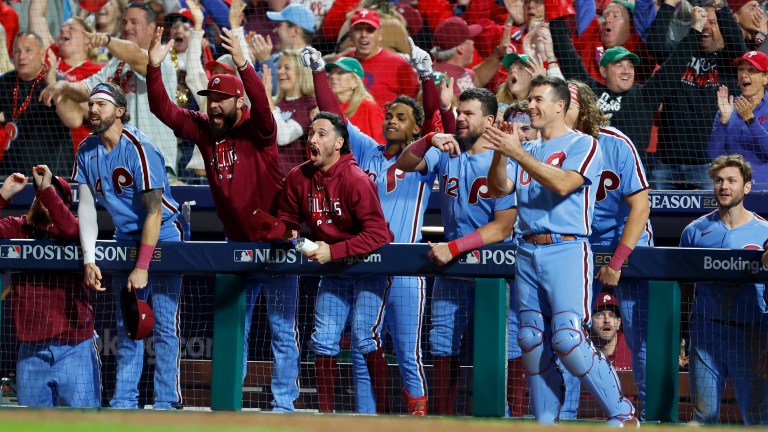 The Philadelphia Phillies bench reacts after Nick Castellanos (not pictured) hit a home run in the sixth inning against the Atlanta Braves during Game Four of the Division Series at Citizens Bank Park.