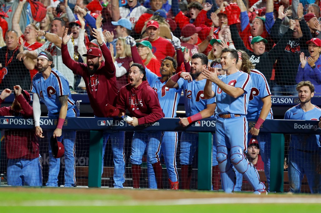 The Philadelphia Phillies bench reacts after Nick Castellanos (not pictured) hit a home run in the sixth inning against the Atlanta Braves during Game Four of the Division Series at Citizens Bank Park.