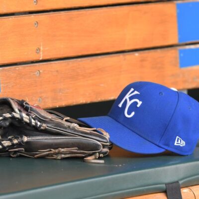 DETROIT, MI - SEPTEMBER 29: A detailed view of a Kansas City Royals baseball hat and glove sitting in the dugout during the game against the Detroit Tigers at Comerica Park on September 29, 2022 in Detroit, Michigan. The Tigers defeated the Royals 10-3. (Photo by Mark Cunningham/MLB Photos via Getty Images)