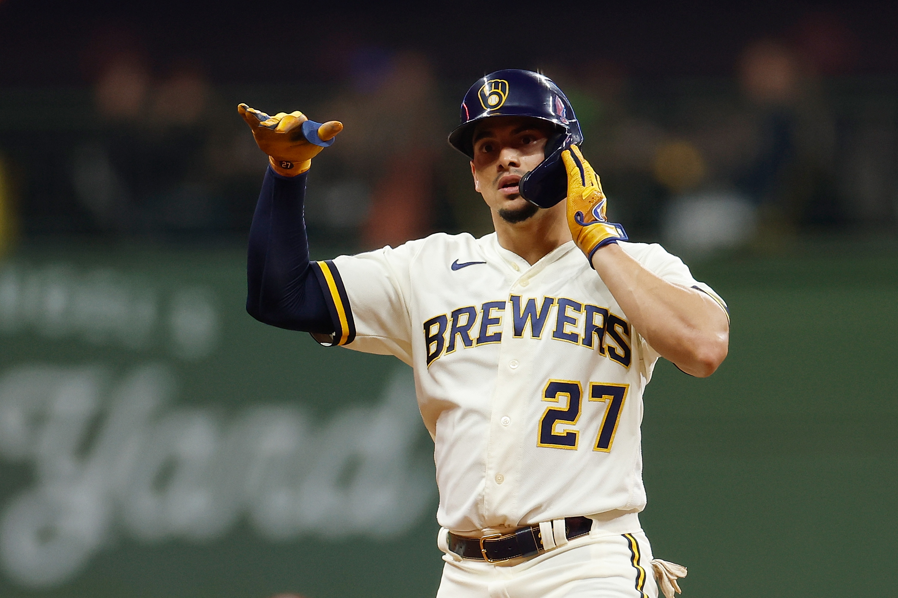 Willy Adames #27 of the Milwaukee Brewers reacts after hitting a double against the St. Louis Cardinals at American Family Field.