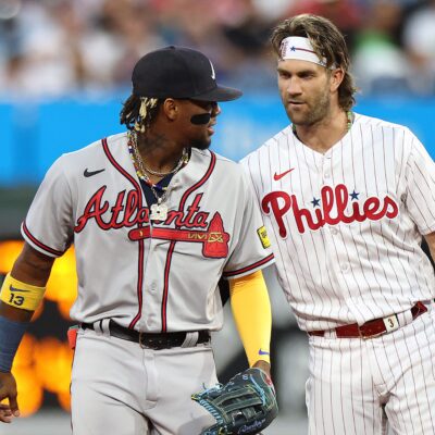 Ronald Acuna Jr. of the Atlanta Braves and Bryce Harper of the Philadelphia Phillies speak during the first inning at Citizens Bank Park.