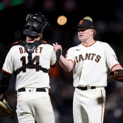 Logan Webb #62 shakes hands with Patrick Bailey #14 of the San Francisco Giants after they beat the San Diego Padres at Oracle Park.