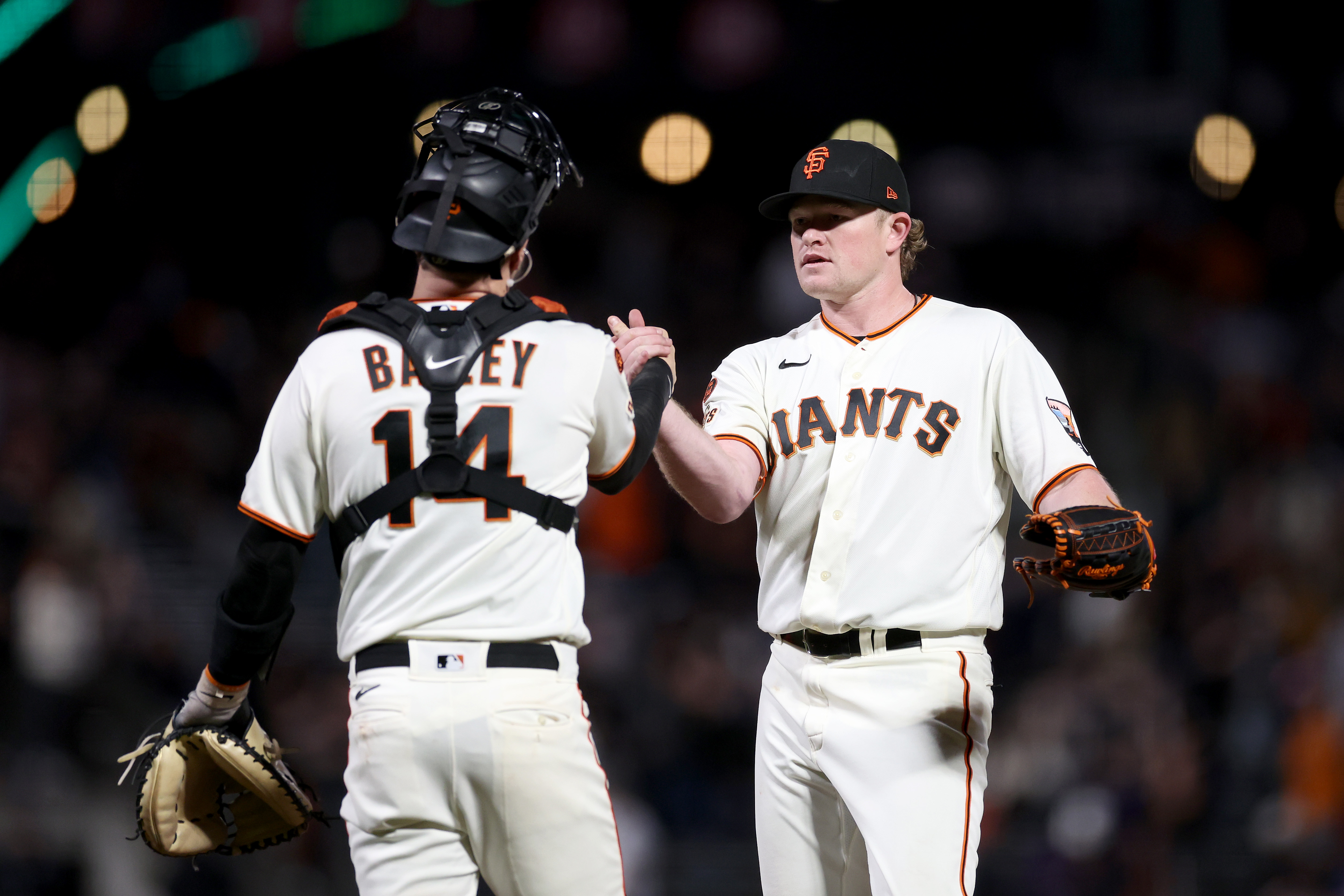 Logan Webb #62 shakes hands with Patrick Bailey #14 of the San Francisco Giants after they beat the San Diego Padres at Oracle Park.