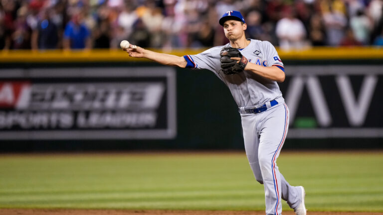 Corey Seager #5 of the Texas Rangers fields the ball during Game Four of the World Series against the Arizona Diamondbacks at Chase Field.