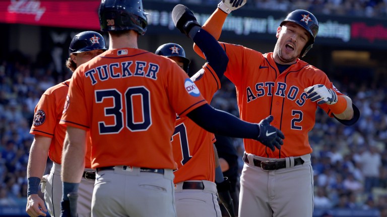 Alex Bregman #2 of the Houston Astros celebrates his grand slam homerun with Jose Altuve #27 and Kyle Tucker #30, to take a 5-3 lead over the Los Angeles Dodgers, during the fifth inning at Dodger Stadium.