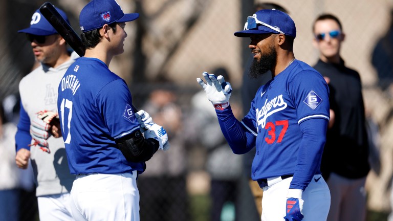 Shohei Ohtani #17 of the Los Angeles Dodgers talks with Teoscar Hernández #37 during workouts at Camelback Ranch.