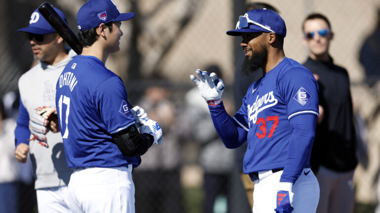 Shohei Ohtani #17 of the Los Angeles Dodgers talks with Teoscar Hernández #37 during workouts at Camelback Ranch.