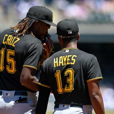 Pittsburgh Pirates shortstop Oneil Cruz (15) has a word with third baseman Ke'Bryan Hayes (13) during a game between the Pittsburgh Pirates and the Colorado Rockies at Coors Field.