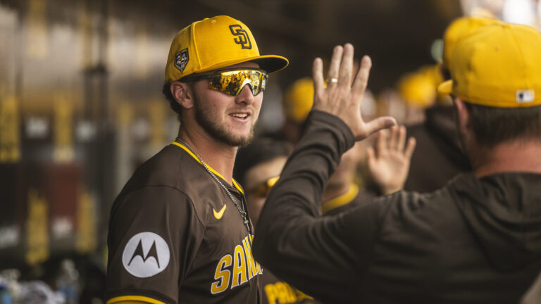 Jackson Merrill of the San Diego Padres hangs out in the dugout during a Spring Training game against the Kansas City Royals at the Peoria Stadium.