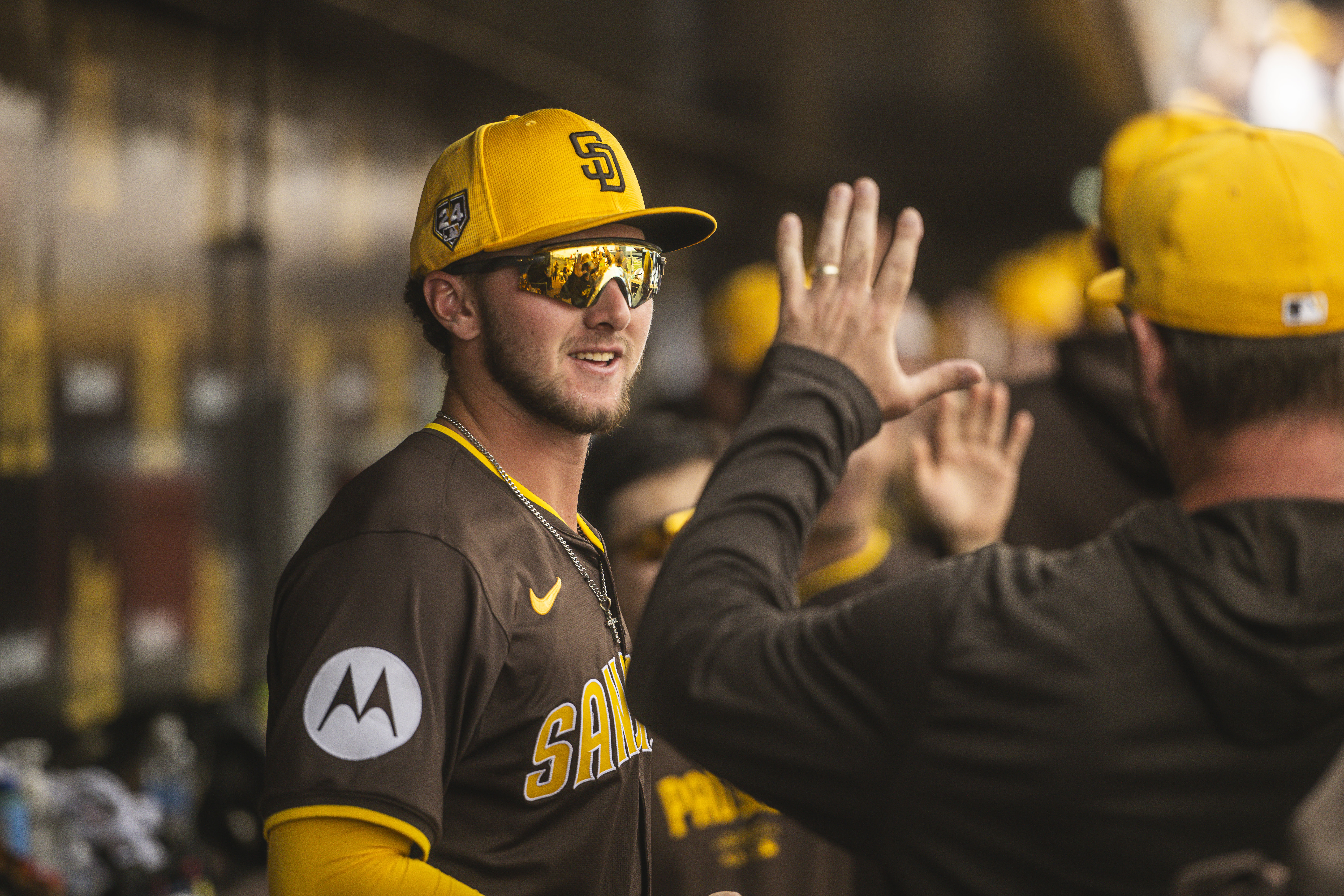 Jackson Merrill of the San Diego Padres hangs out in the dugout during a Spring Training game against the Kansas City Royals at the Peoria Stadium.