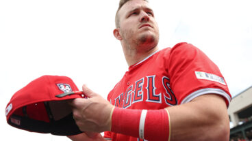 Mike Trout #27 of the Los Angeles Angels looks on during a spring training exhibition against the Los Angeles Dodgers at the Peoria Sports Complex.