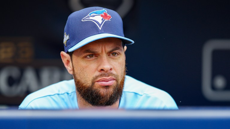 Brandon Belt of the Toronto Blue Jays looks on from the dugout before Game 1 of the Wild Card Series between the Toronto Blue Jays and the Minnesota Twins at Target Field.