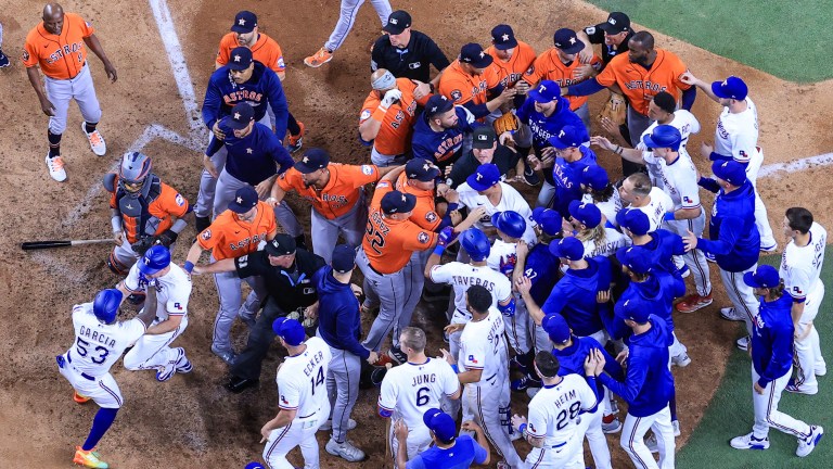 Adolis Garcia of the Texas Rangers argues with Martin Maldonado #15 of the Houston Astros after being hit by a pitch by Bryan Abreu #52 of the Houston Astros causing benches to clear during the eighth inning in Game Five of the American League Championship Series at Globe Life Field.