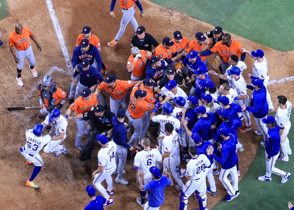 Adolis Garcia of the Texas Rangers argues with Martin Maldonado #15 of the Houston Astros after being hit by a pitch by Bryan Abreu #52 of the Houston Astros causing benches to clear during the eighth inning in Game Five of the American League Championship Series at Globe Life Field.