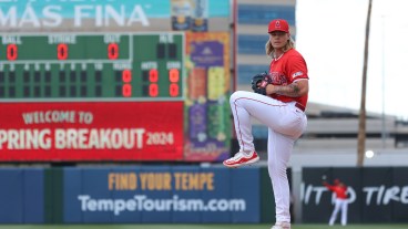 Caden Dana of the Los Angeles Angels warms up prior to the 2024 Spring Breakout Game between the Los Angeles Dodgers and the Los Angeles Angels at Tempe Diablo Stadium.