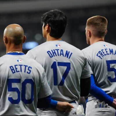 Mookie Betts #50, Shohei Ohtani #17 and Freddie Freeman #5 of the Los Angeles Dodgers look on during the national anthem prior to the 2024 Seoul Series game between the Los Angeles Dodgers and the San Diego Padres at Gocheok Sky Dome.